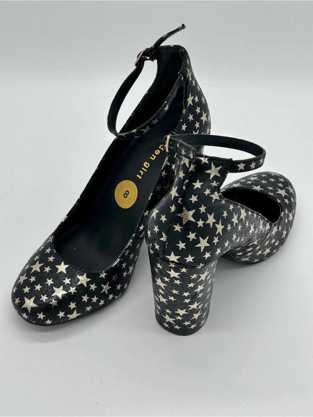 Madden Girl “Prinnce” Metallic Black and Gold Stars Block Heel Ankle Strap Pumps